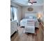 Bedroom with a white bed, chair and dresser at 301 E Grace St, Punta Gorda, FL 33950
