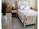 Bedroom with white furniture, bed and a nightstand with lamp at 301 E Grace St, Punta Gorda, FL 33950
