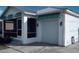 A single story home features a screened in porch and attached garage at 301 E Grace St, Punta Gorda, FL 33950