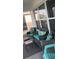 Comfortable outdoor seating with teal accents on screened in porch at 301 E Grace St, Punta Gorda, FL 33950