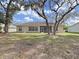 House exterior view with large backyard and mature trees at 3307 Kilmer Pl, Plant City, FL 33566