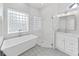 Spa-like bathroom with soaking tub, walk-in shower, and patterned tile at 3307 Kilmer Pl, Plant City, FL 33566