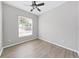 Well-lit bedroom with wood-look floors and window blinds at 3307 Kilmer Pl, Plant City, FL 33566