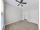 Bedroom with wood-look floors, ceiling fan, and ample closet space at 3307 Kilmer Pl, Plant City, FL 33566