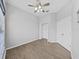 Bright bedroom with wood-look floors, double doors, and a spacious closet at 3307 Kilmer Pl, Plant City, FL 33566