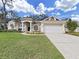 Beautiful one-story home with a two-car garage and lush landscaping at 3307 Kilmer Pl, Plant City, FL 33566
