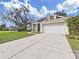 House exterior showcasing a two-car garage and well-maintained lawn at 3307 Kilmer Pl, Plant City, FL 33566