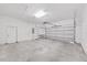 Attached garage with automatic door opener and storage shelving at 3307 Kilmer Pl, Plant City, FL 33566