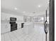 Modern kitchen featuring white cabinets and black appliances at 3307 Kilmer Pl, Plant City, FL 33566
