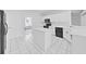 White kitchen with an island and tile flooring at 3307 Kilmer Pl, Plant City, FL 33566