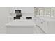 Modern kitchen features white cabinets, black appliances, and a spacious island at 3307 Kilmer Pl, Plant City, FL 33566
