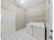 Laundry room with washer, dryer, and ample shelving at 3307 Kilmer Pl, Plant City, FL 33566
