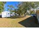 Large backyard with shed and mature oak tree at 3522 E 26Th Ave, Tampa, FL 33605
