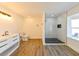 Modern bathroom with white vanity, walk-in shower, and vinyl flooring at 3522 E 26Th Ave, Tampa, FL 33605