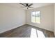Bright bedroom featuring wood-look floors and large window at 3522 E 26Th Ave, Tampa, FL 33605