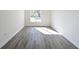 Bright and airy bedroom with wood-look floors and a large window at 3522 E 26Th Ave, Tampa, FL 33605