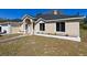 Tan one-story house with a landscaped front yard and attached garage at 3522 E 26Th Ave, Tampa, FL 33605