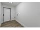 Laundry room with white door and wood-look flooring at 3522 E 26Th Ave, Tampa, FL 33605