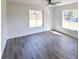 Living room with wood-look floors and two large windows at 3522 E 26Th Ave, Tampa, FL 33605