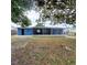 Large backyard with mature trees behind the house at 3546 Cheswick Dr, Holiday, FL 34691
