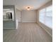 Bright dining room with wood-look tile flooring and large windows at 3546 Cheswick Dr, Holiday, FL 34691