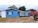 Ranch home with blue exterior and landscaped yard at 3546 Cheswick Dr, Holiday, FL 34691