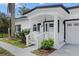 Charming house exterior with white siding, black accents, and a covered porch at 3811 River Grove Ct, Tampa, FL 33610