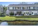 An inviting backyard with a view of the lake, a patio area, and a lush green lawn at 388 Countryside Key Blvd, Oldsmar, FL 34677