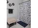 Clean bathroom with shower curtain, towels, and small ottoman at 388 Countryside Key Blvd, Oldsmar, FL 34677