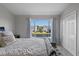 Main bedroom with water view and plush bedding at 388 Countryside Key Blvd, Oldsmar, FL 34677