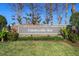 The community's sign 'Countryside Key' is surrounded by green grass and landscaping at 388 Countryside Key Blvd, Oldsmar, FL 34677