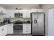Modern kitchen with stainless steel appliances and white cabinets at 388 Countryside Key Blvd, Oldsmar, FL 34677