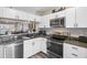 Modern kitchen with stainless steel appliances and granite countertops at 388 Countryside Key Blvd, Oldsmar, FL 34677