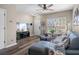 Living room with sectional sofa, TV, and wood-look floors at 388 Countryside Key Blvd, Oldsmar, FL 34677