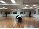 Large ballroom with hardwood floors, long table, and ambient lighting at 401 Dorchester Pl # 62, Sun City Center, FL 33573