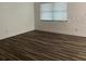 Bright bedroom with wood-look floors and large window at 401 Dorchester Pl # 62, Sun City Center, FL 33573