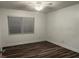 Bright bedroom with wood-look floors and large window at 401 Dorchester Pl # 62, Sun City Center, FL 33573