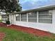 Side view of house with large windows and landscaping at 401 Dorchester Pl # 62, Sun City Center, FL 33573