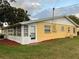 Ranch-style home with a sunroom and carport at 401 Dorchester Pl # 62, Sun City Center, FL 33573