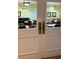 View of a game room with tables and chairs through glass doors at 401 Dorchester Pl # 62, Sun City Center, FL 33573
