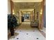 Elegant building hallway with tiled floors and plants at 401 Dorchester Pl # 62, Sun City Center, FL 33573
