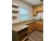 Kitchen with wood cabinets, granite countertops, and ample storage space at 401 Dorchester Pl # 62, Sun City Center, FL 33573