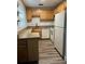 Full view of kitchen with wood cabinets, granite countertops and stainless steel appliances at 401 Dorchester Pl # 62, Sun City Center, FL 33573