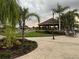 Community patio with tables, chairs, and a gazebo at 401 Dorchester Pl # 62, Sun City Center, FL 33573