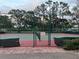Community tennis court with surrounding trees at 401 Dorchester Pl # 62, Sun City Center, FL 33573