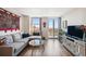 Open living area with L-shaped sofa, hardwood floors, and balcony access at 4015 Bayshore Blvd # 9D, Tampa, FL 33611