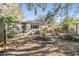 Backyard with stone pathway, shed, and lush landscaping at 4711 Olive Dr, Zephyrhills, FL 33542