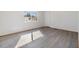 Simple bedroom with wood-look flooring and large window at 4711 Olive Dr, Zephyrhills, FL 33542