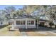 White single story home with carport and mature trees at 4711 Olive Dr, Zephyrhills, FL 33542