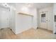 Home hallway with light wood flooring and storage at 4711 Olive Dr, Zephyrhills, FL 33542